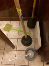 couple of plungers bathroom scale and toilet bowl cleaner brush