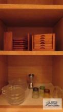 Lot of wooden coaster sets, glass coasters, and shot glasses