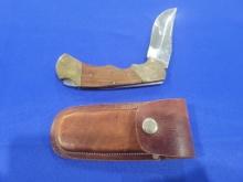 Folding Knife Folding knife, comes with leather belt holster, no name, wooden handles and what appea